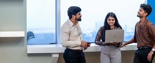 Group of people talking with laptop