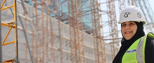 Woman in hard hat on site