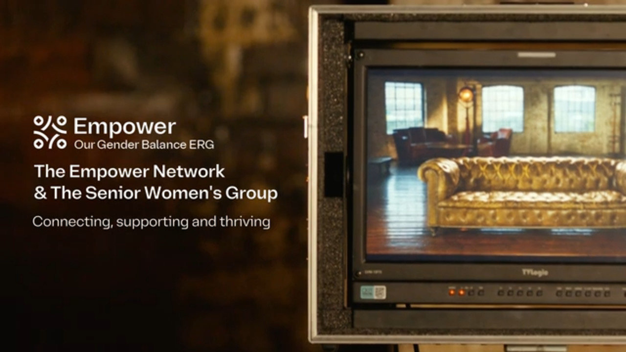 A display screen shows a vintage-style room with a golden tufted sofa, while text beside it reads: "Empower – Our Gender Balance ERG. The Empower Network & The Senior Women's Group. Connecting, supporting and thriving.