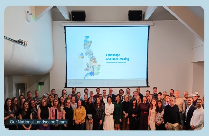 Group photo of the National Landscape Team in front of a screen titled "Landscape and Place-making.
