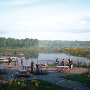 Nature park with boardwalks and people overlooking lake