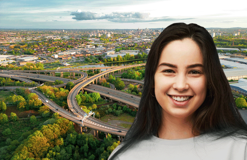 Smiling young woman with long dark hair standing in front of a cityscape with a sprawling highway interchange, symbolizing diversity and inclusion.