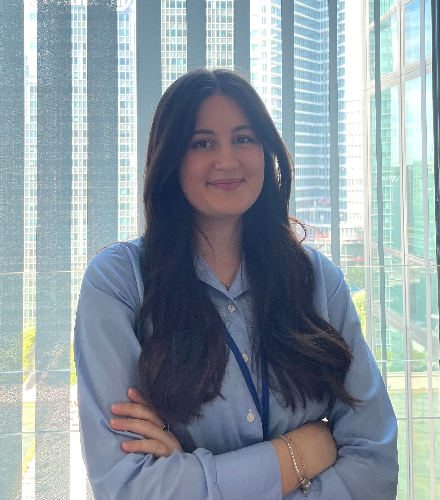 Woman in blue shirt in glass office