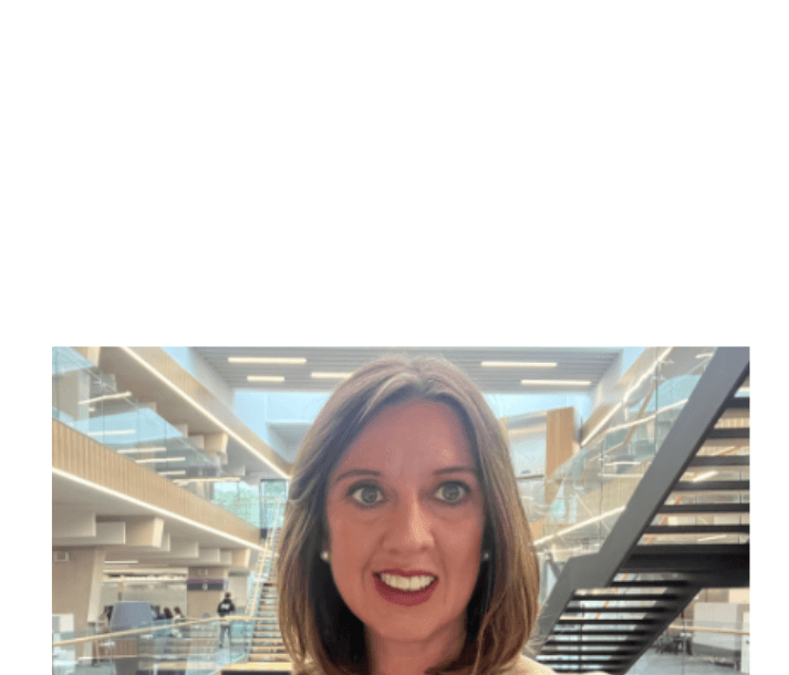 Woman in business attire standing inside modern building