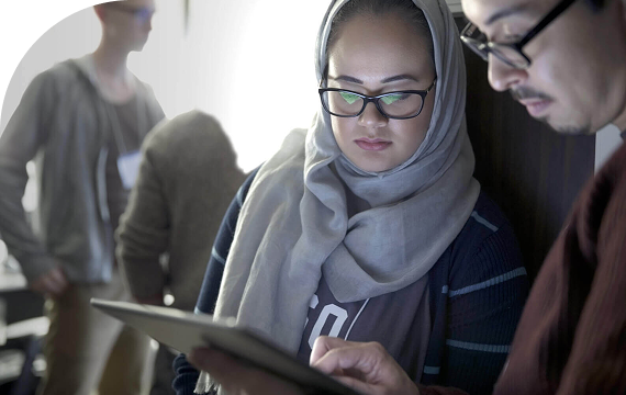 two women checking tablet