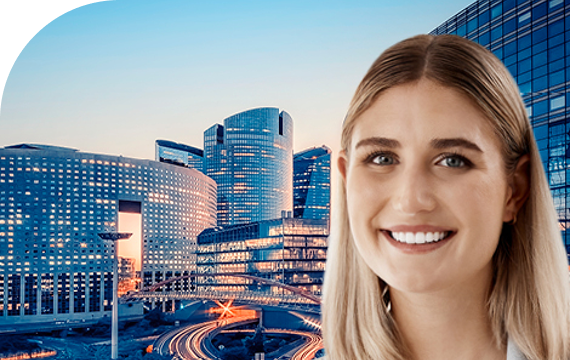 a woman smiling and buildings in background