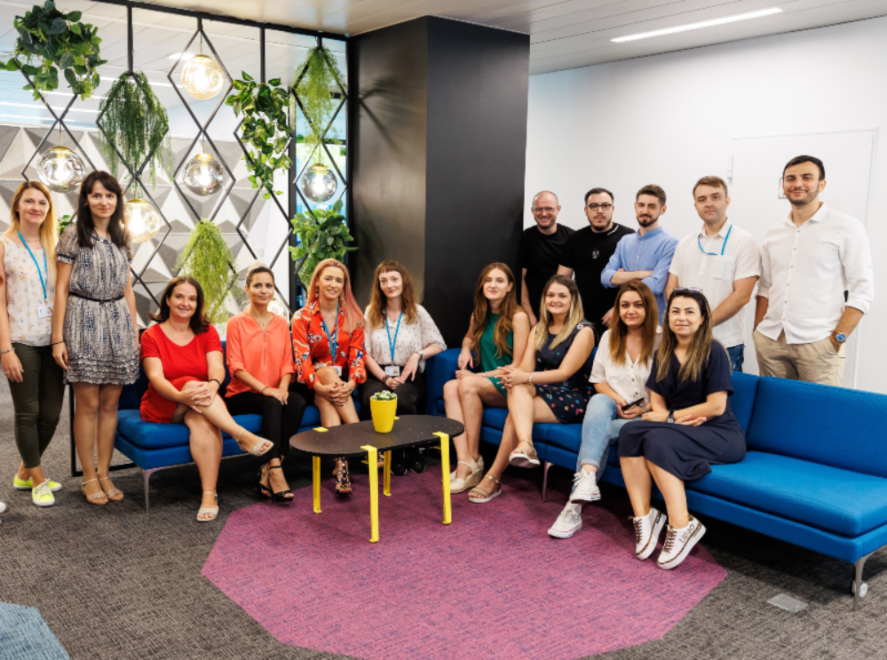 Corporate team group photo in office lounge