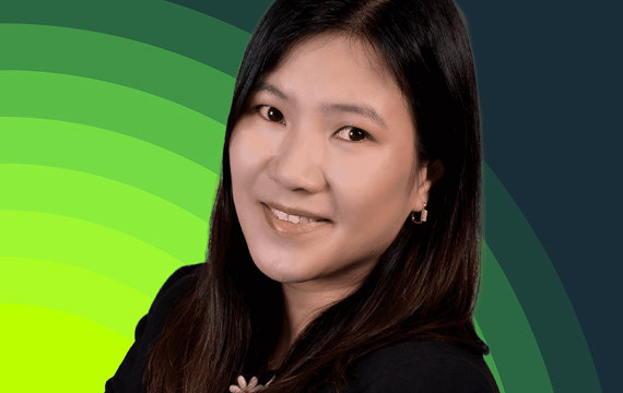 Professional headshot of an Asian businesswoman smiling, wearing a black blazer, with a green and dark blue gradient background.