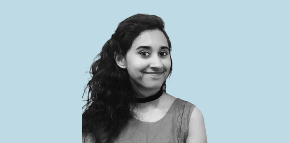 Portrait of a woman with long curly hair smiling