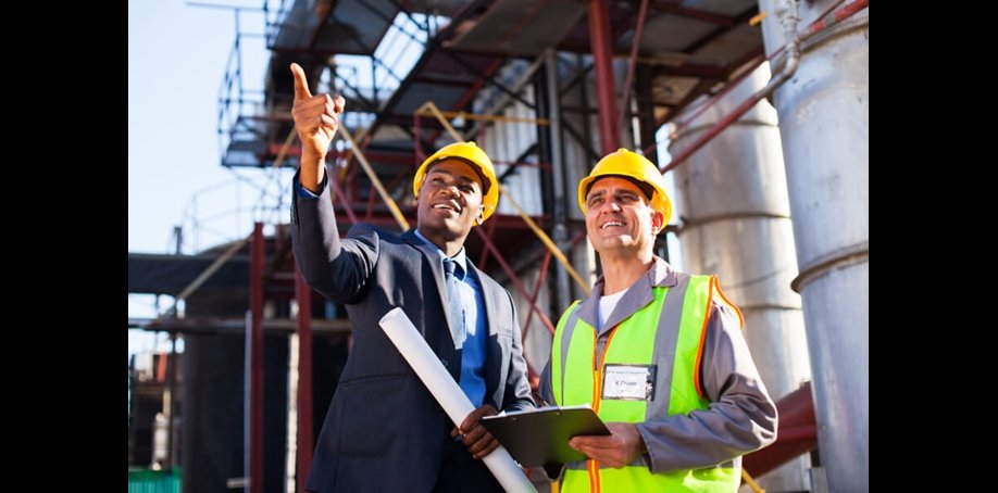 Two engineers on site pointing into the distance