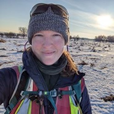 Alison Smiling towards the camera in the snow