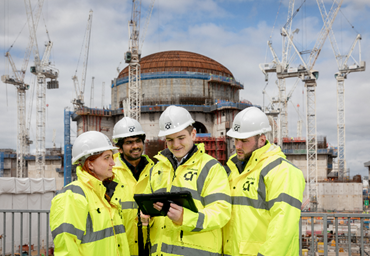 group of 4 engineers in AtkinsRéalis site kit on site at Hinkley Point C