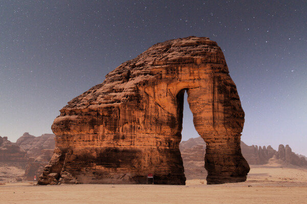 Famous Elephant Rock in AlUla, Saudi Arabia, under a starry night sky.
