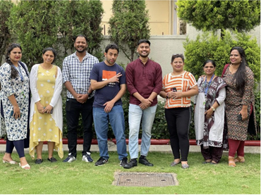Team of people sitting outdoors together