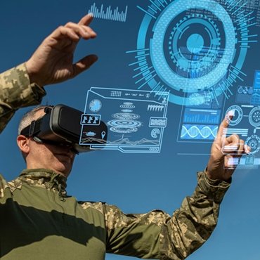 a man standing against a blue sky wearing an AI visor with graphics in front of him