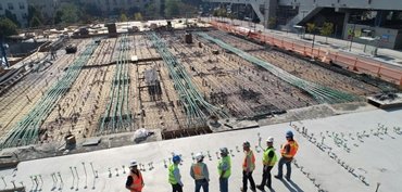 group of engineers looking over large construction site with pipes