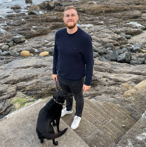 Photo of David with his dog near the beach
