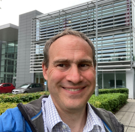 Photo of Adam smiling towards the camera