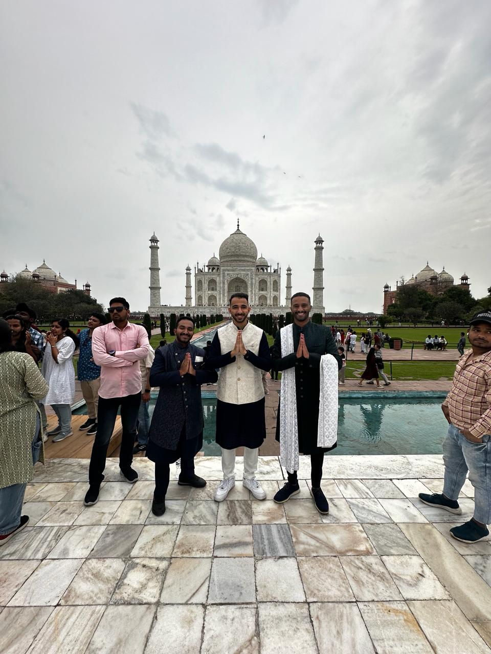 A group of people in front of Taj Mahal
