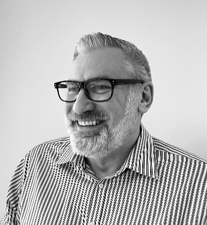 Photo of Dean smiling towards the camera