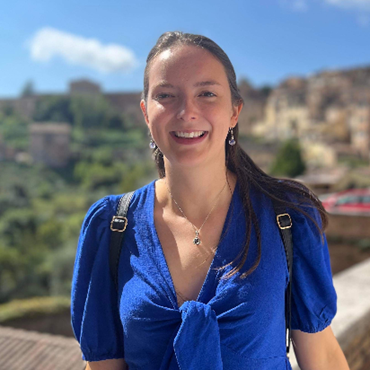 Jo, wearing a bright blue top and smiling into the camera