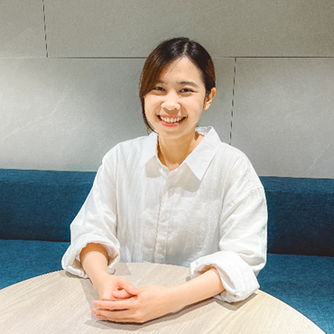 Picture of Wannacha smiling in a white shirt.