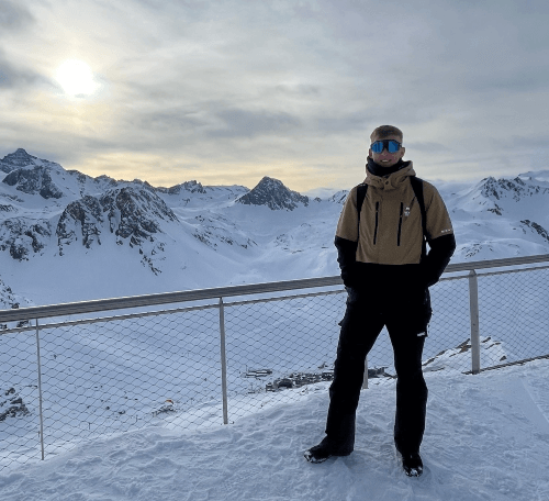 Ryley standing near snowy mountains