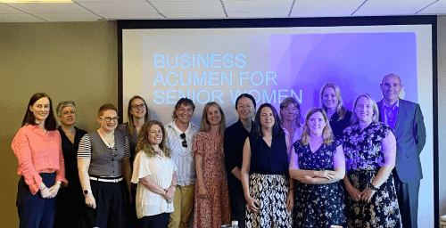 A group picture of Carly and her teammates in a meeting room