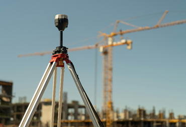 surveying tool with a crane in the background