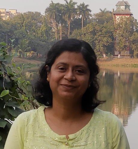 Picture of Prabhati standing in front of a lake