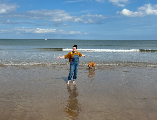 Anna with her pet dog on the beach