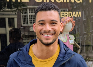 Headshot of Aston smiling at the camera