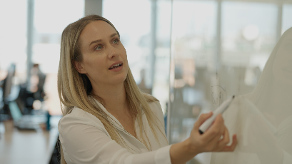 Image of Eliza writing on a board