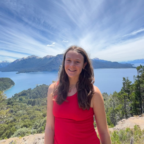 Beautiful picture of Olivia standing in front of a lake and hills