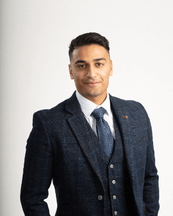 Photo of Akram smiling towards the camera