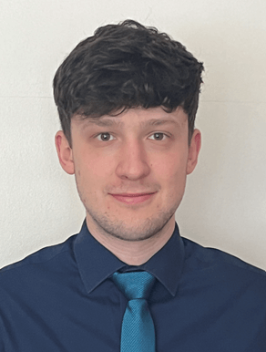 A passport size photo of Tom